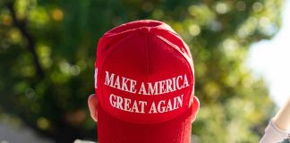 Person wearing a red "Make America Great Again" hat.