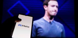 Person holding smartphone with Meta logo displayed