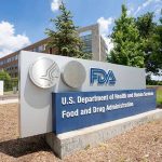 FDA Approves New Revolutionary Non-Opioid Pain Management Option FDA building sign with blue sky background.