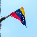 Are US Citizens Involved in a Mysterious Plot in Venezuela? Venezuelan flag flying on a pole.