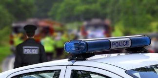 Police car and officer at a scene.