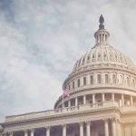 Unveiling a Bold Plan: A New Amendment to Reshape Congress Capitol dome with American flag, under cloudy sky.