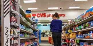 Person shopping in a CVS pharmacy aisle