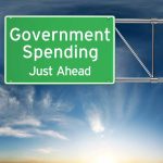 Green road sign: "Government Spending Just Ahead."