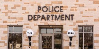 Police department building with brick exterior and signage.