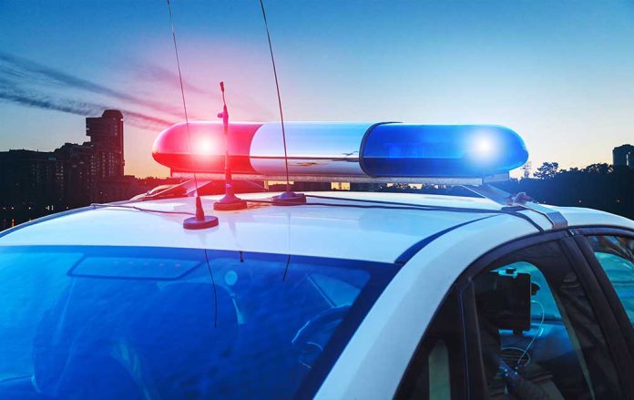 1386445574 featured image Police car with flashing red and blue lights.