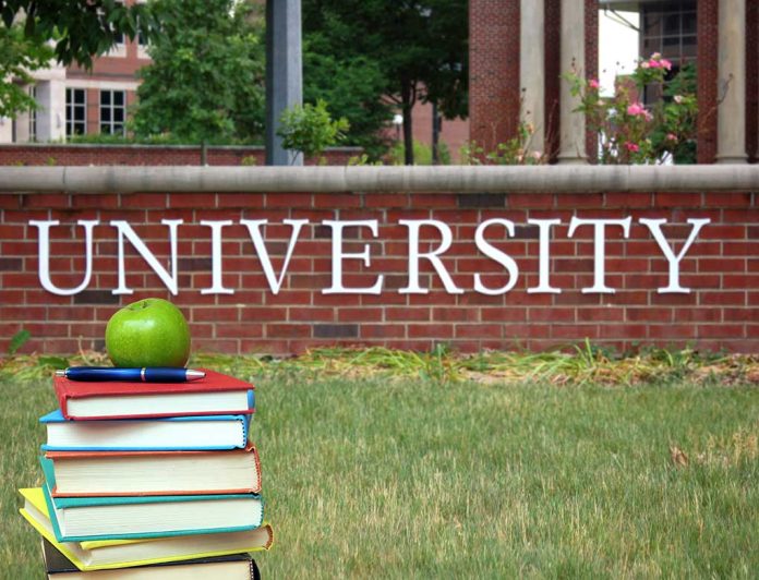 141582367 featured image Books and apple in front of university sign