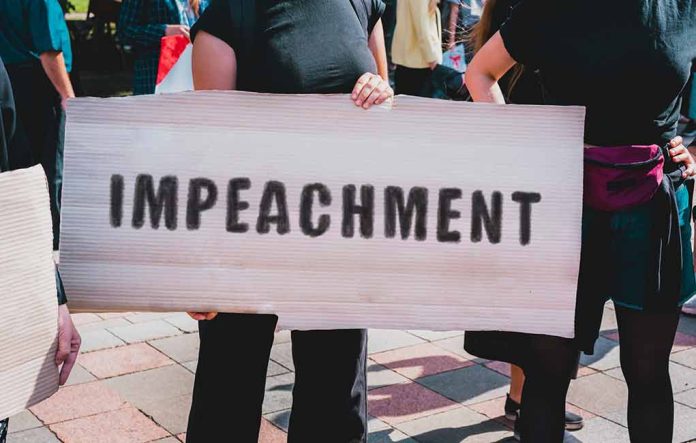 1518100937 featured image Person holding an Impeachment sign at protest.