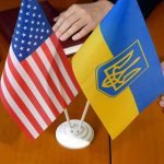 USA and Ukraine flags on a table