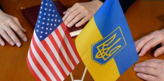 USA and Ukraine flags on a table