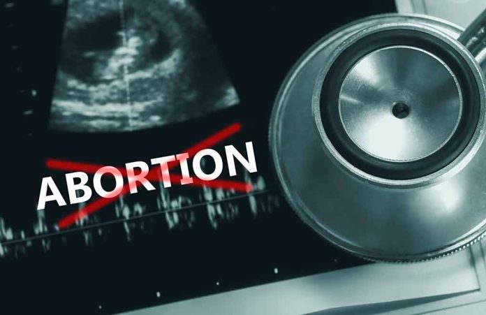 2171348999 featured image Ultrasound, stethoscope, and "ABORTION" crossed out in red.