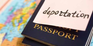 Passports stacked with deportation note on top.