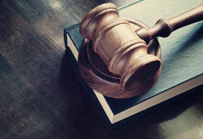 299616500 featured image Wooden gavel resting on thick book