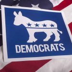 Rethinking Party Ideals and Journalism’s Role in Holding Media Accountable Democrats logo with donkey on American flag background