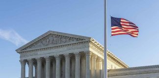 US flag flying outside a neoclassical government building