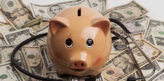 Piggy bank with stethoscope on dollar bills