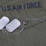 Military jacket with dog tags on the pocket.