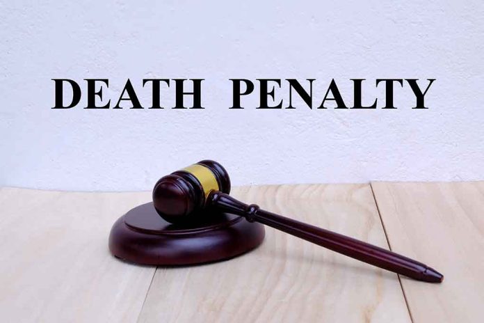 Gavel under "Death Penalty" text on white background. featured image Gavel under "Death Penalty" text on white background.