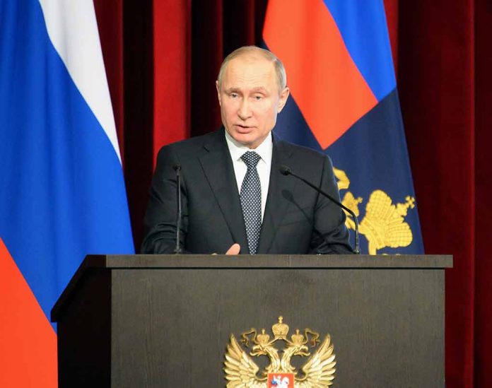 1038561886 featured image Man speaking at podium with flags behind him
