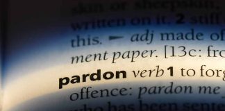 The word pardon highlighted in a dictionary.