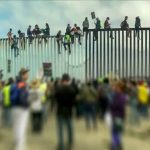 Unveiling the New Border Security Blueprint: Beyond Wall Construction Strategies People sitting on high metal fence during protest.