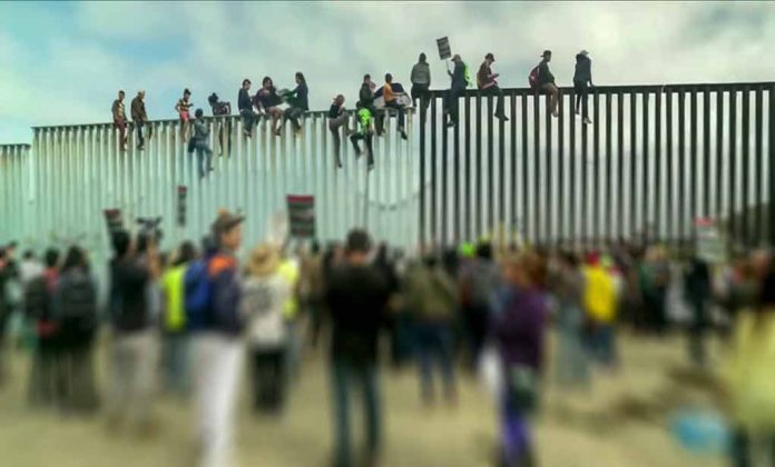 1229072281 featured image People sitting on high metal fence during protest.