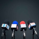 Microphones set up for a news conference