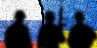 Silhouettes on split Russian and Ukrainian flags background