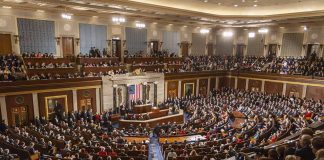 Large audience seated in a formal legislative chamber