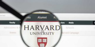 Magnifying glass over Harvard University webpage text and logo
