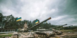 Tanks with flags in muddy forest environment