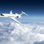 Private jet flying above the clouds.