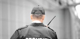 Security guard holding a walkie-talkie.