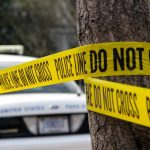 Mystery Surrounds Homicide Victim Found in Brigham City, Utah Yellow police tape around tree near car
