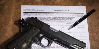 Gun and pen on firearm transaction form