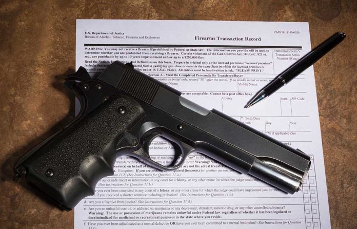 1026045637 featured image Gun and pen on firearm transaction form