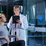 Woman undergoing brain scan with doctor monitoring results