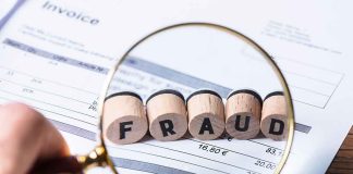 Magnifying glass showing FRAUD on an invoice