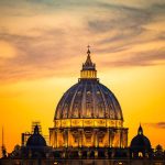 Dome of a cathedral at sunset with orange sky