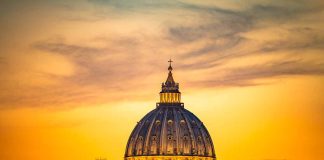 Dome of a cathedral at sunset with orange sky