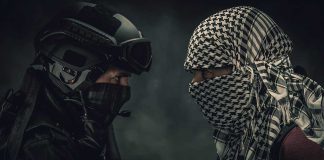 Two masked figures face each other dramatic lighting