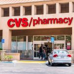 CVS Pharmacy store entrance with parked cars outside