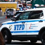 NYPD police car on a city street scene