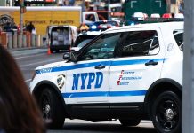 NYPD police car on a city street scene