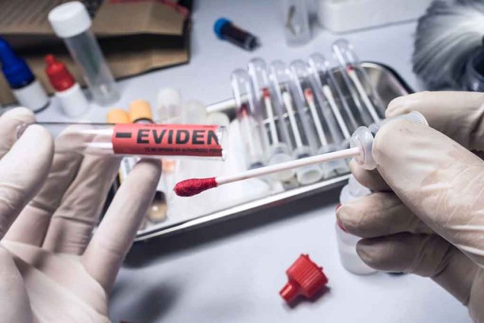 Gloved hands holding evidence tube and cotton swab