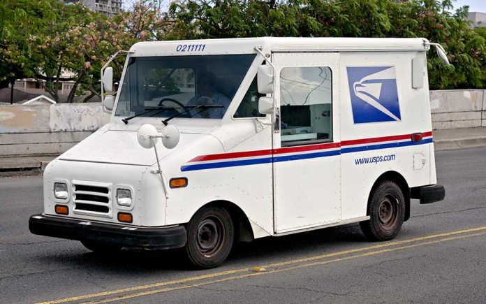 USPS mail truck driving down the street