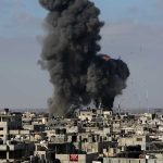 Large black smoke clouds over urban area