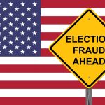 Yellow sign reading Election Fraud Ahead with American flag