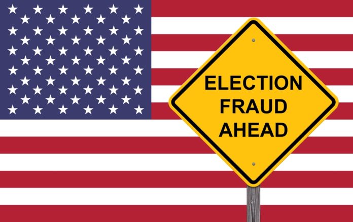 Yellow sign reading Election Fraud Ahead with American flag