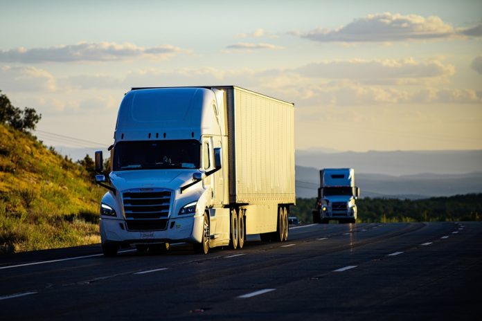 2146415481 featured image Two semitrucks driving on a highway
